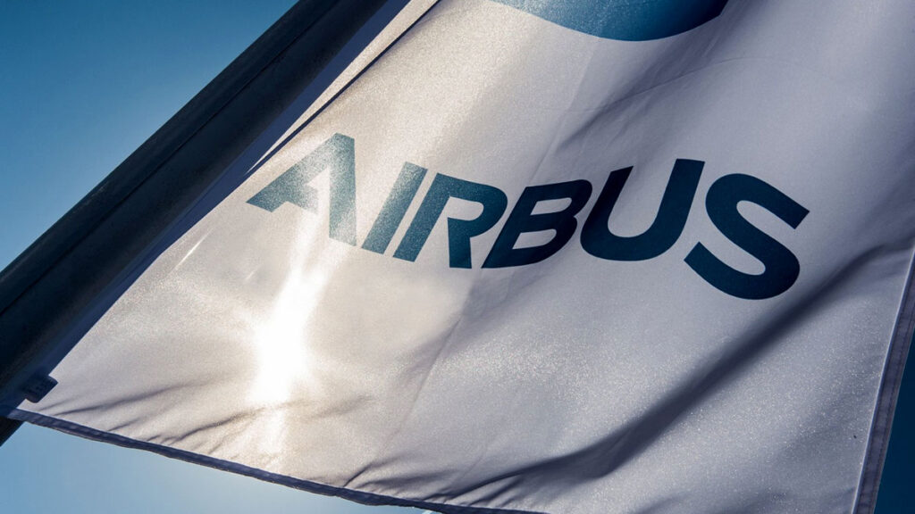América Latina necesitará 2.720 aviones comerciales nuevos para 2045 Bandera blanca con el logotipo corporativo azul de Airbus ondeando al viento bajo un cielo despejado.