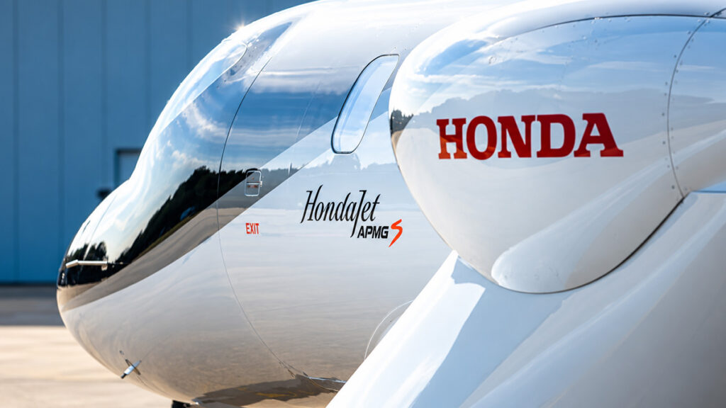 Primer plano del fuselaje de un HondaJet mostrando el logotipo corporativo y la insignia de la actualización APMG S.